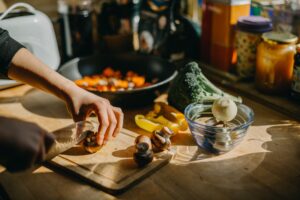 5 Benefits of Self-Catering Accommodation - person cutting up vegetables