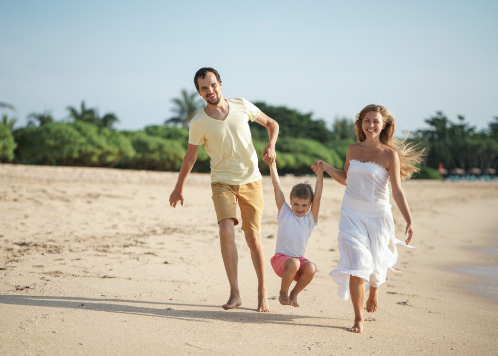5 Benefits of Self-Catering Accommodation - parents with child on beach